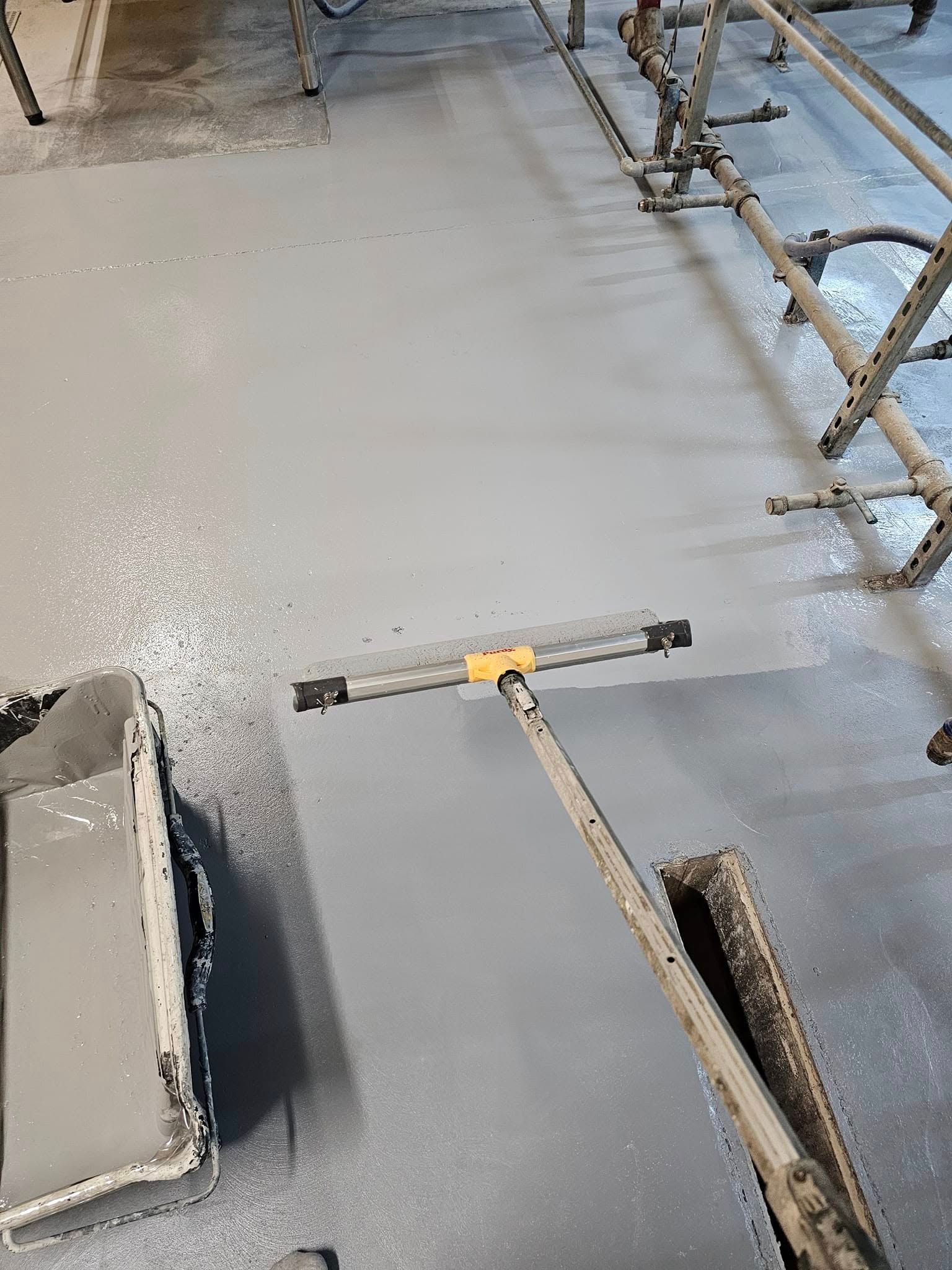 A person using a squeegee to smooth wet