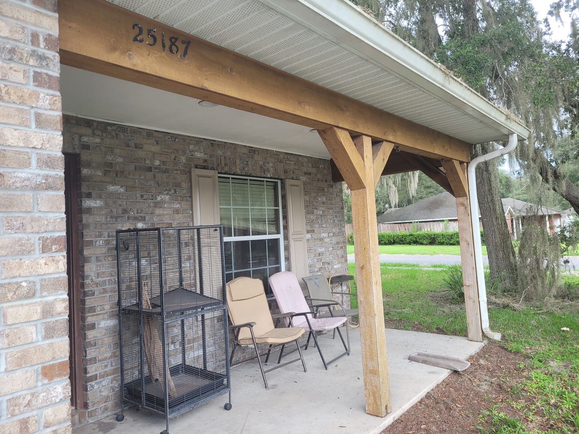 A brick house porch with wooden beams