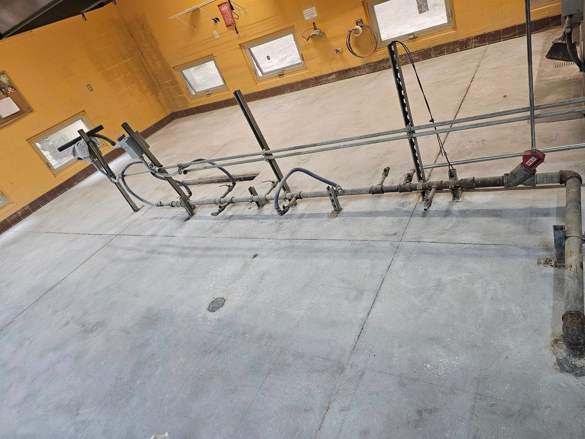 Bike rack on a concrete floor in a yellow-walled building