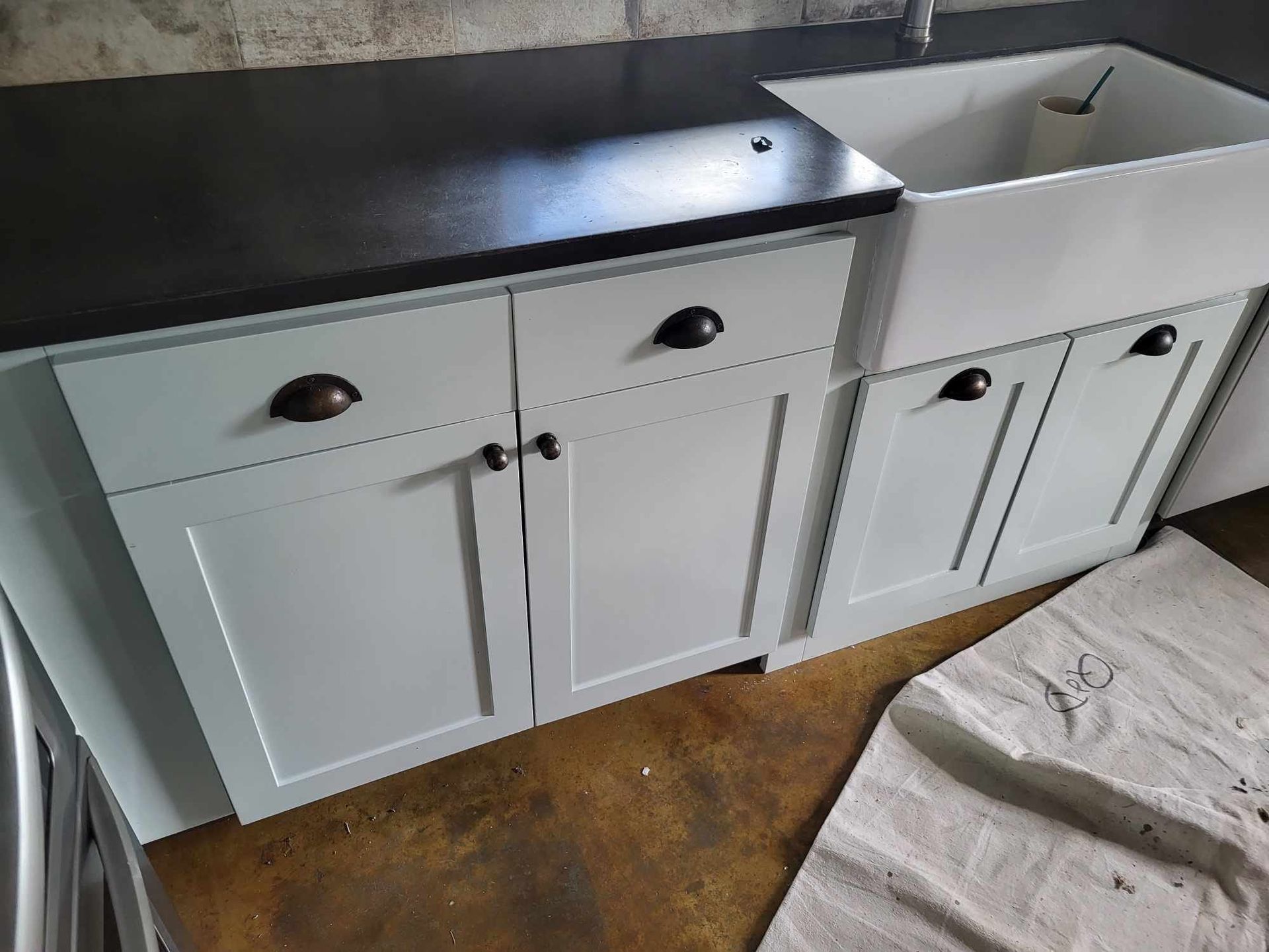 Light blue kitchen cabinets with black countertop