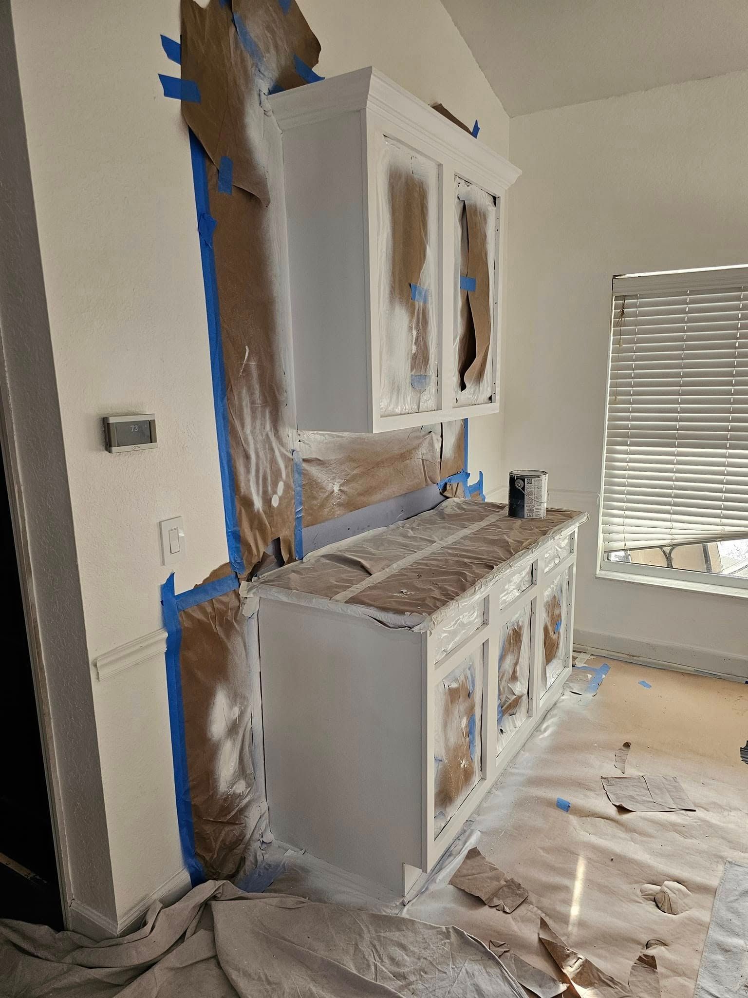 Kitchen cabinets being painted white