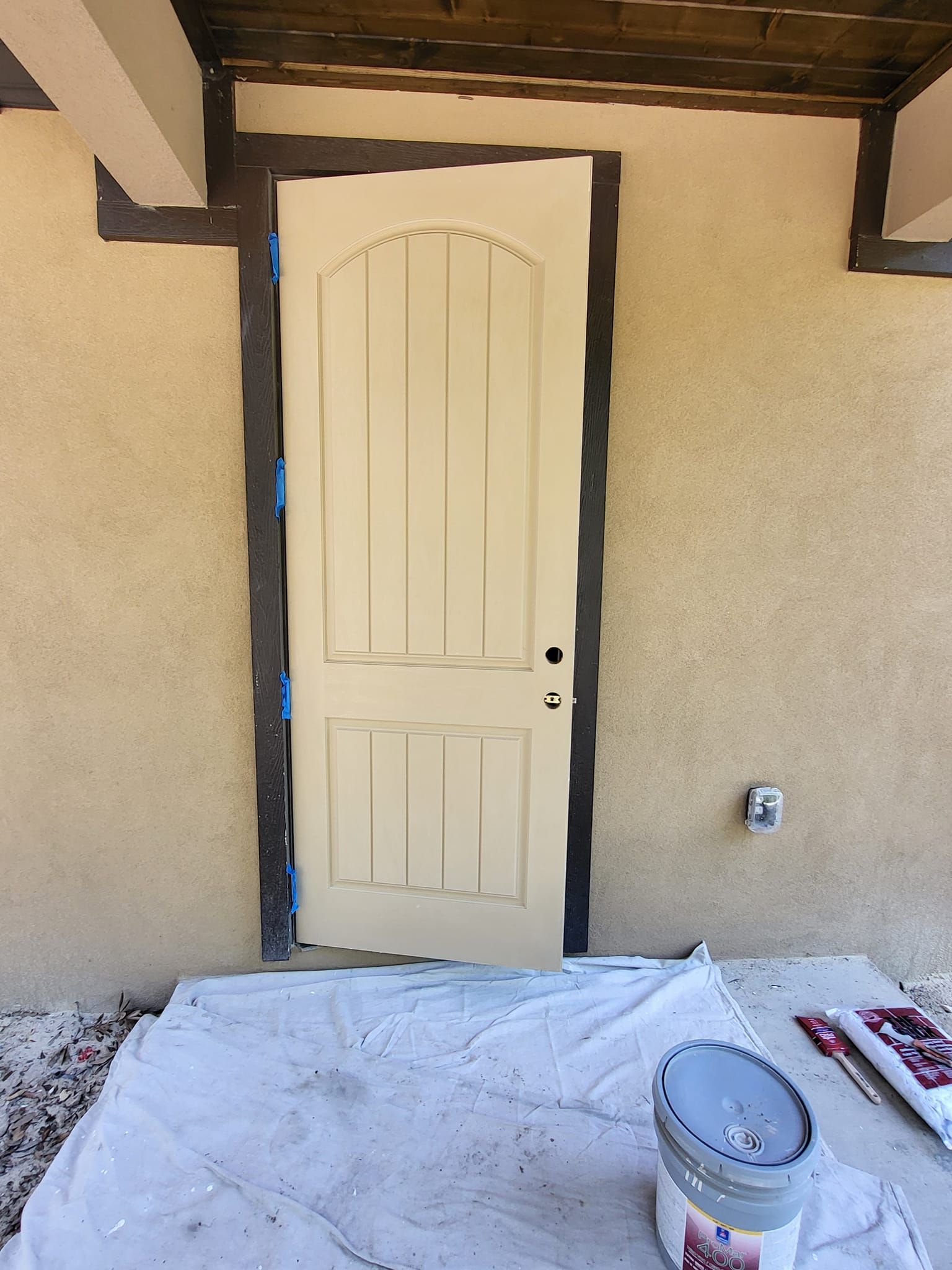 Beige door against a beige stucco wall