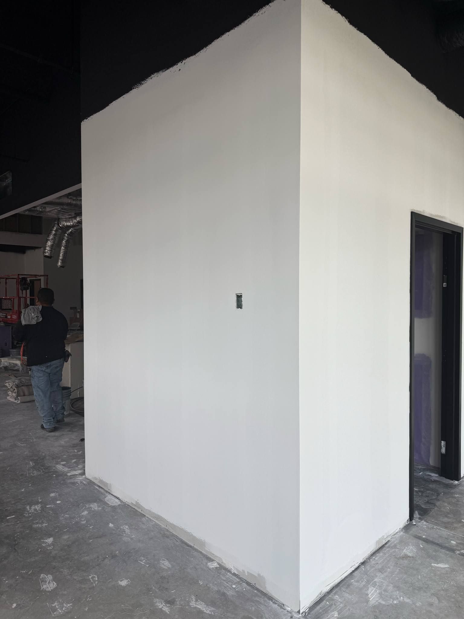 Corner of a newly painted white wall in an unfinished building