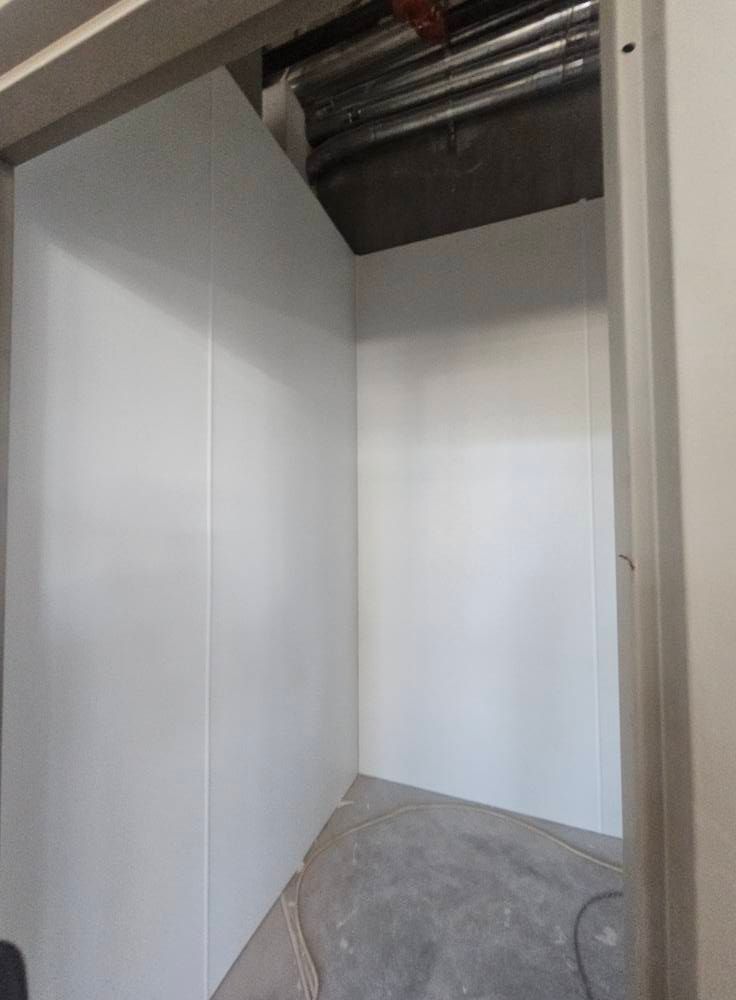 White-walled room corner with concrete floor