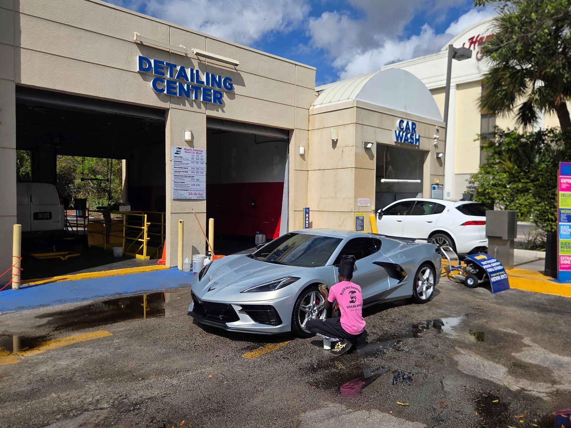 White Mercedes coupe with chrome wheels parked outdoors.