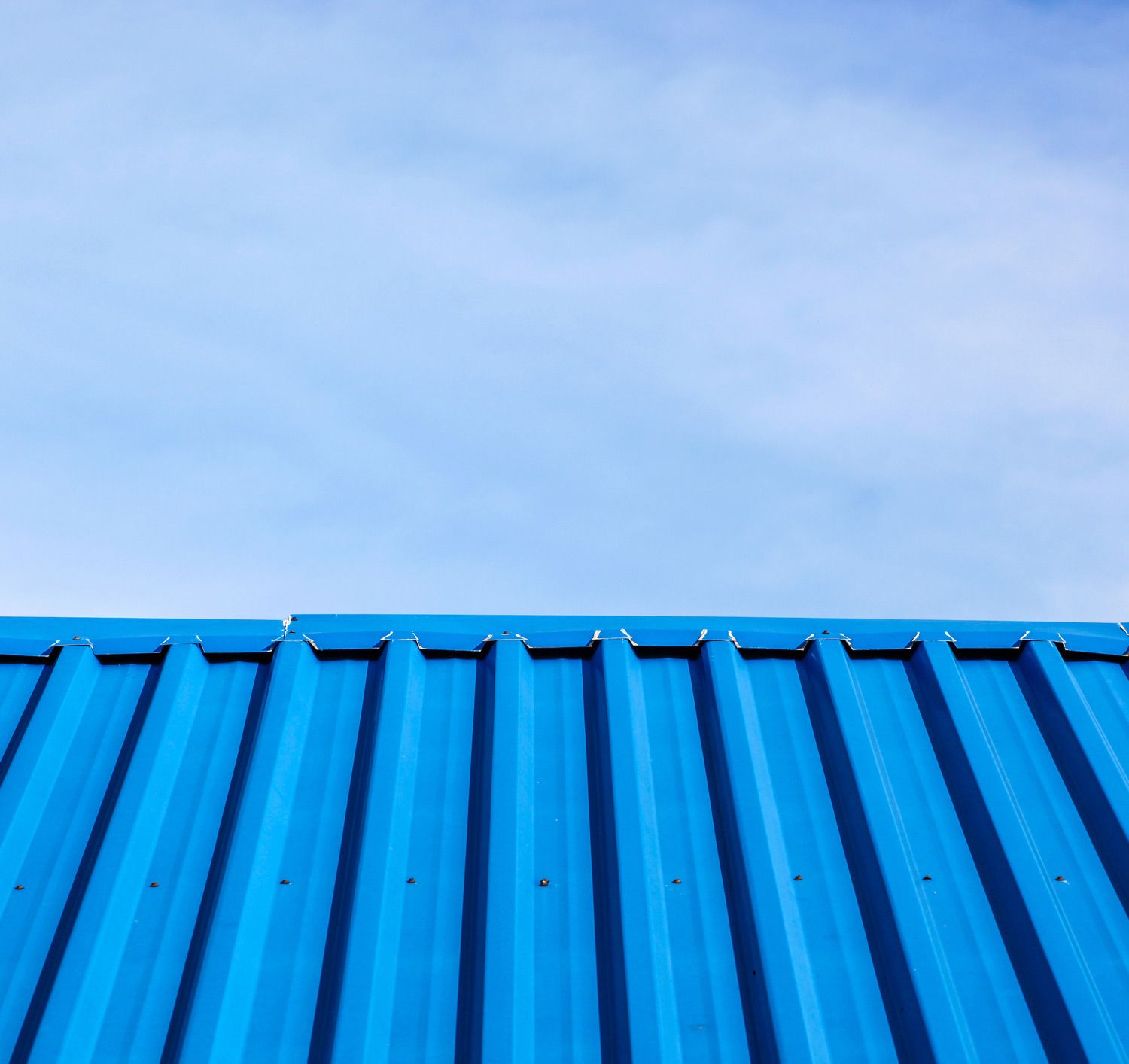 Blue corrugated metal roof against a clear blue sky Blue corrugated metal roof against a clear blue sky