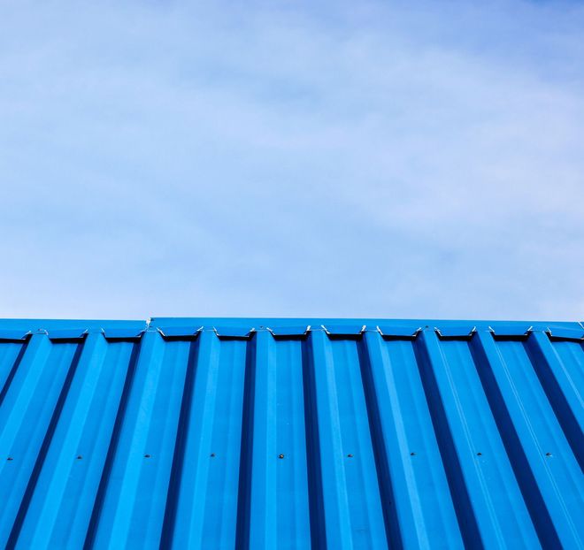 Blue corrugated metal roof against a clear blue sky Blue corrugated metal roof against a clear blue sky