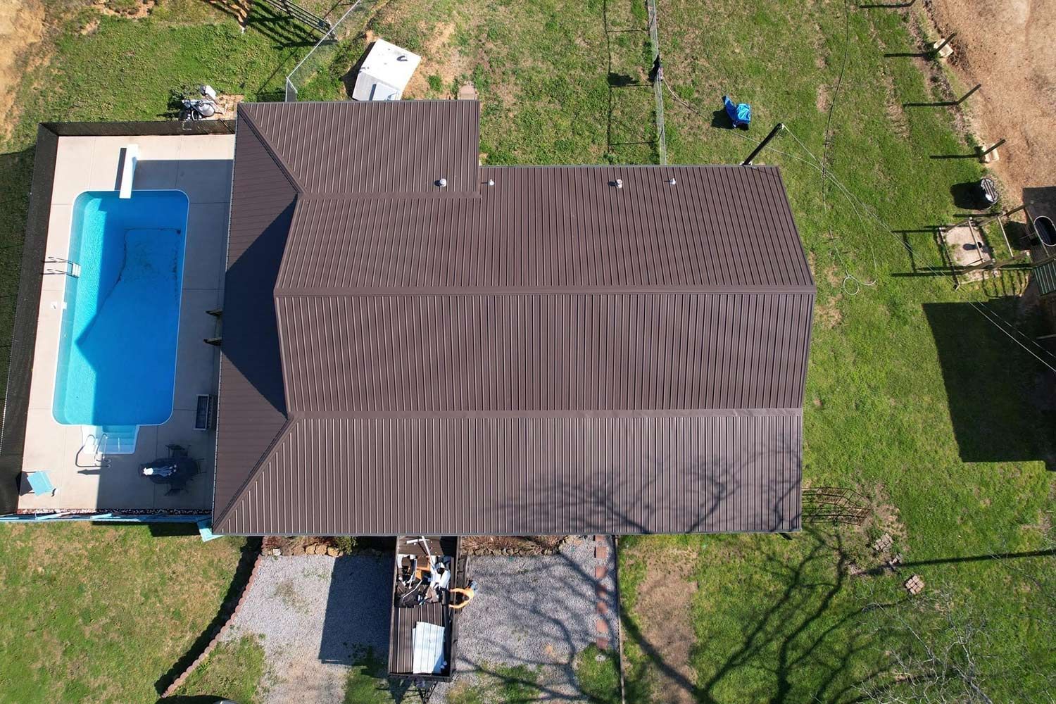 Aerial view of a house with a brown metal roof