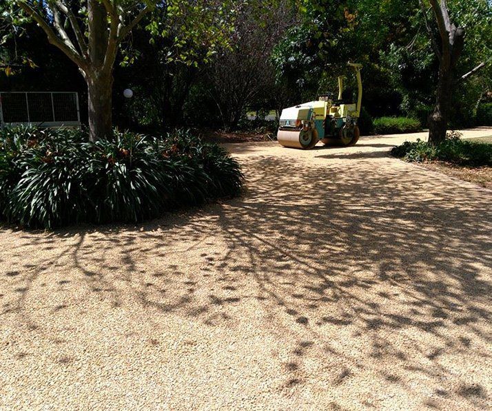 Machine Driving Over Gravel Driveway — Landscaping in Southern Highlands, NSW