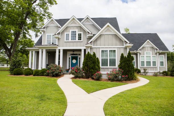 A large house with a blue door and a walkway leading to it.