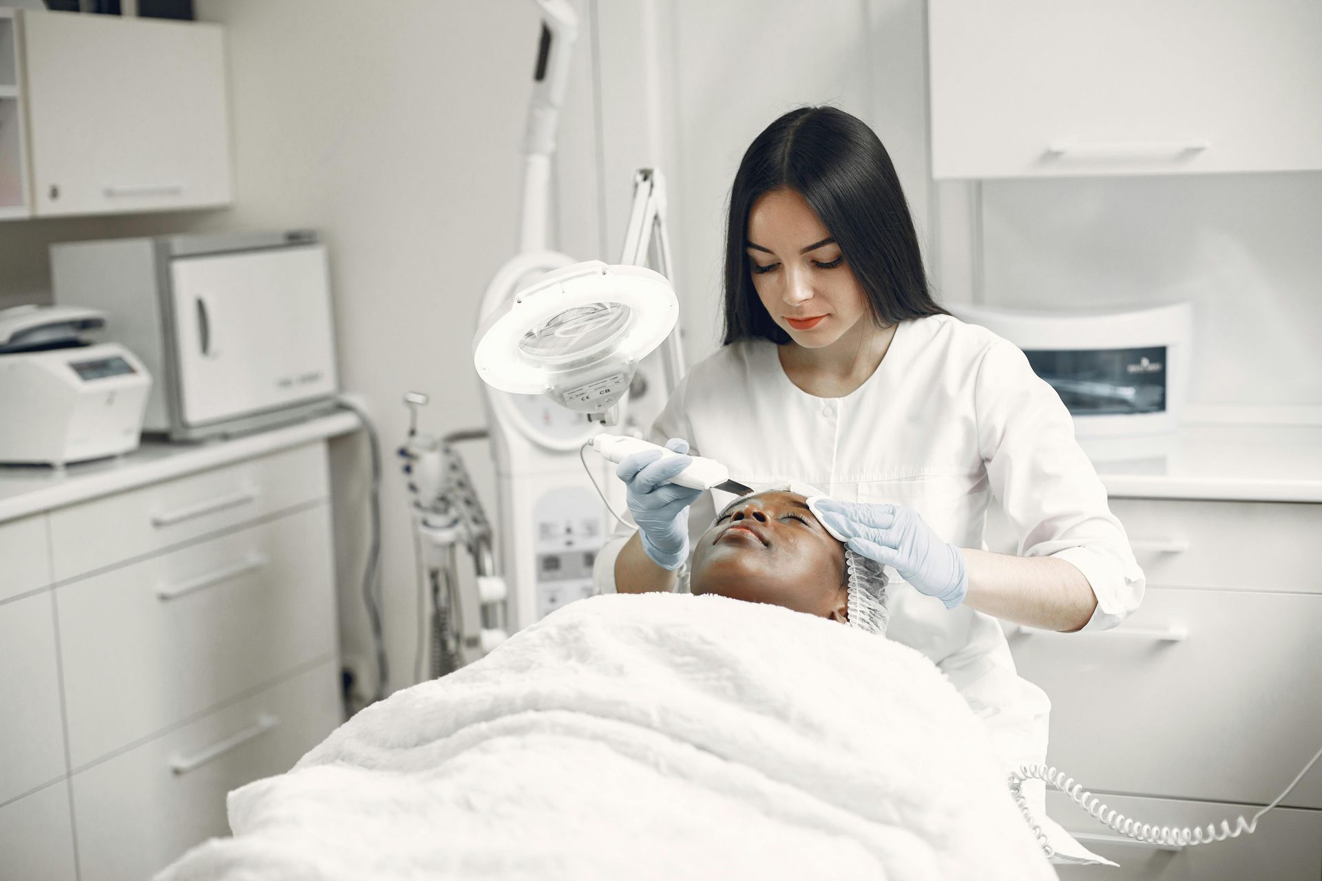 Lady performing medical spa treatment from The Real Social