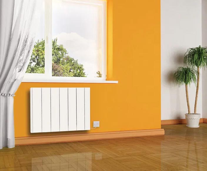 Radiator fitted to an orange wall