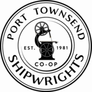 Logo for Port Townsend Shipwrights Co-op, featuring a circular design with text and a central illustration of a band saw.