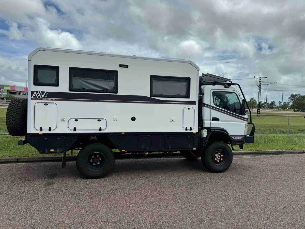 A White And Black Camper Van Is Parked On The Side Of The Road — Prestige Automotive NT In Yarrawonga, NT