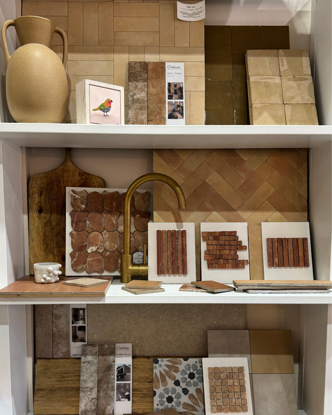 A Display Shelf Showcasing Various Textured Tiles, Pottery and a Gold Faucet — Stone Arc in Kincumber, NSW
