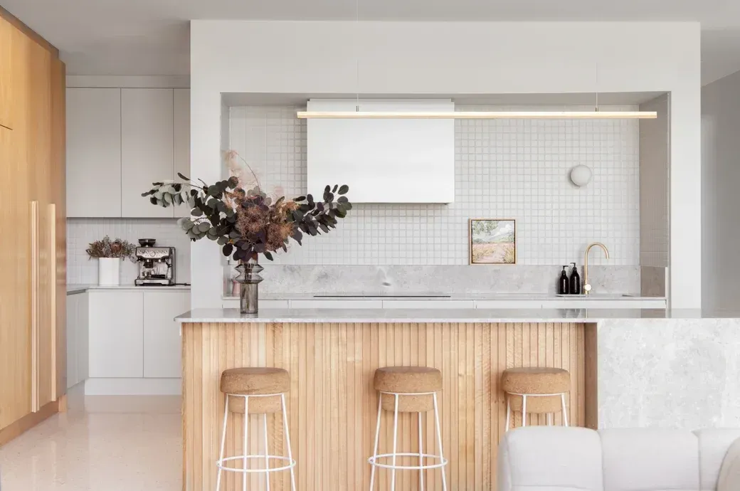 A Kitchen With A Wooden Island And Three Stools  — Stone Arc in Kincumber, NSW