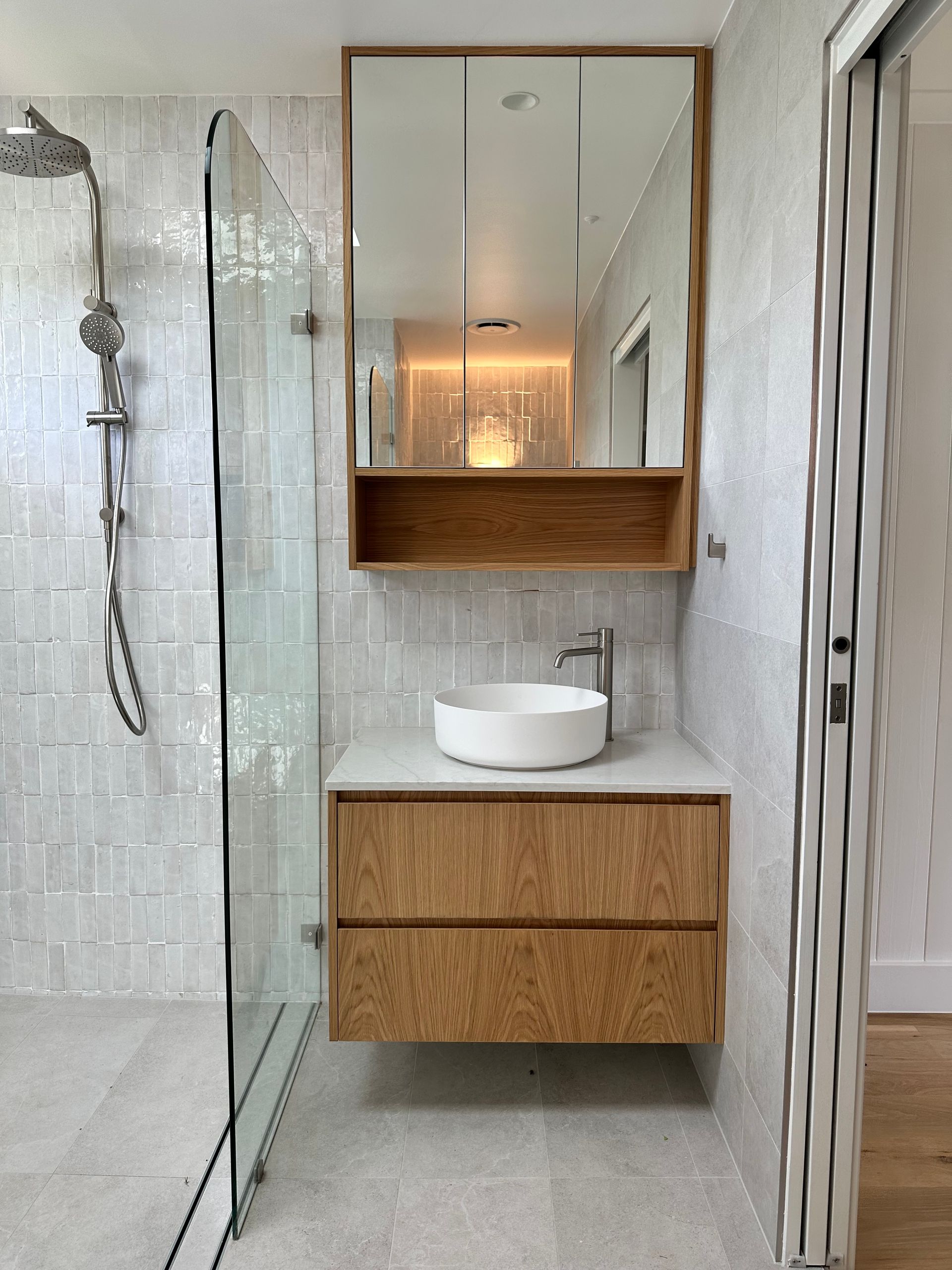 Modern Bathroom With Floating Oak Vanity, White Countertop, Round Sink and Mirrored Cabinet — Stone Arc in Kincumber, NSW