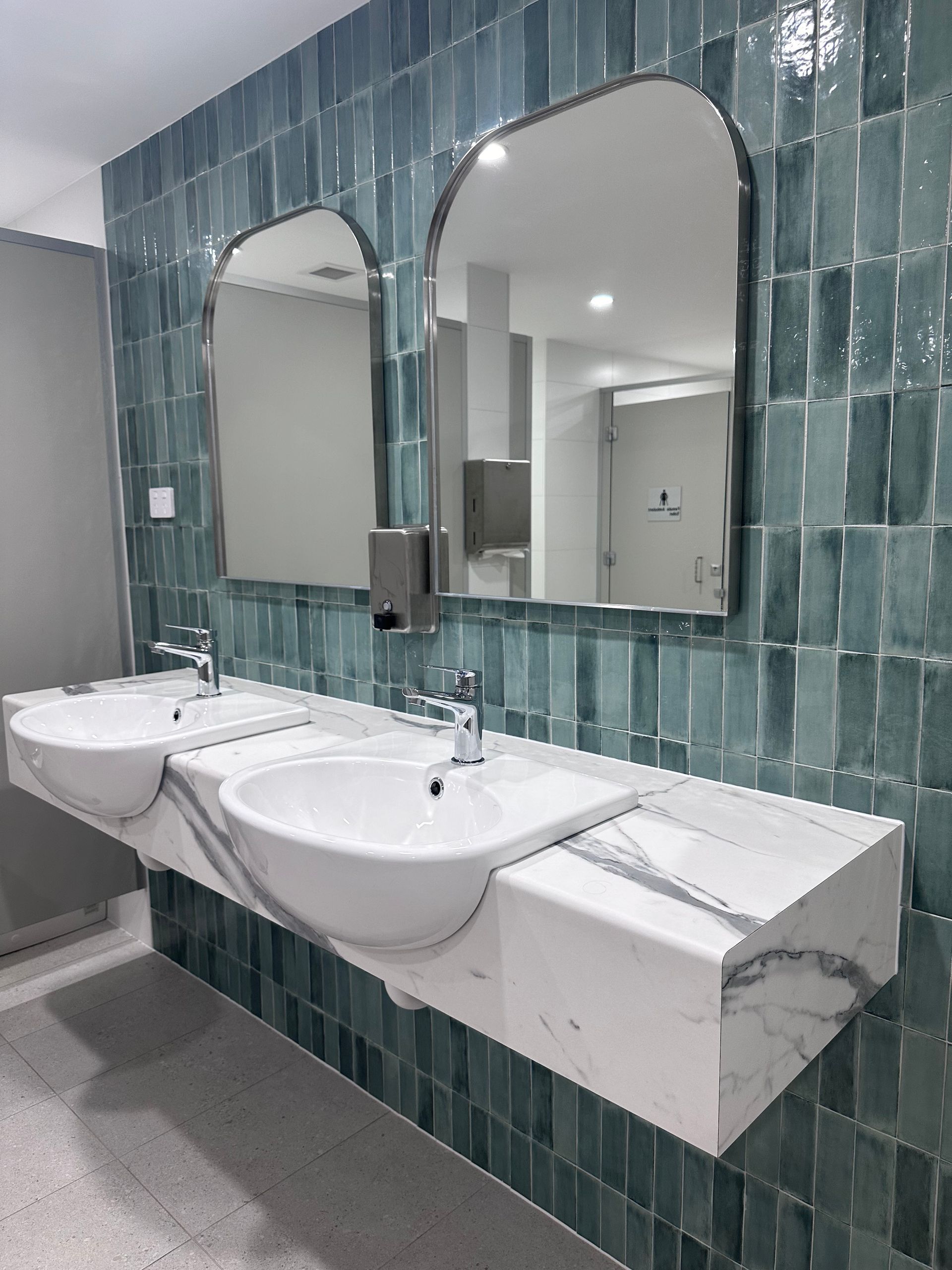 Bathroom With Two Sinks, Marble Countertop, Teal Tile, and Arched Mirrors — Stone Arc in Kincumber, NSW