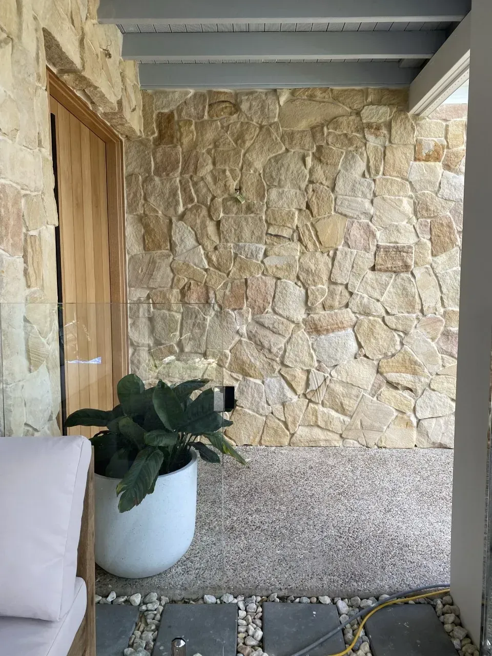 Stone Wall and Wooden Door Next to a Potted Plant — Stone Arc in Kincumber, NSW