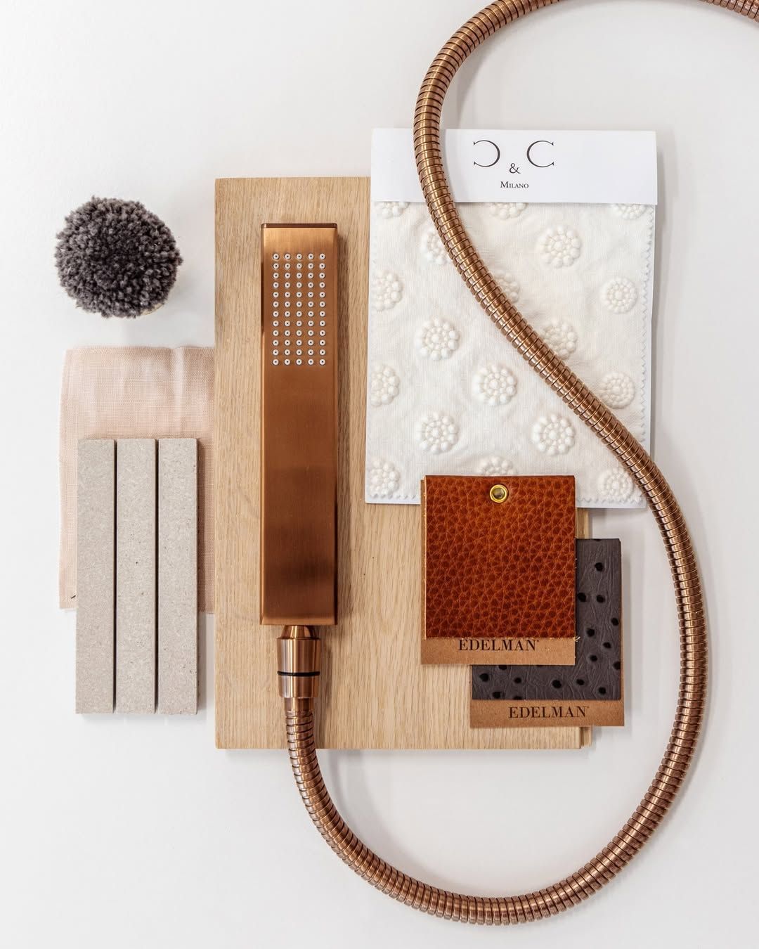 Copper Showerhead and Hose With Fabric and Material Samples on White Background — Stone Arc in Kincumber, NSW