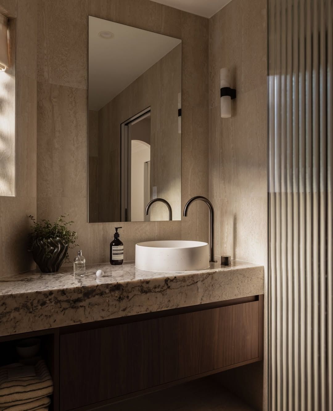 Bathroom With a Round White Sink on a Stone Countertop, Wood Cabinet, Large Mirror and Walls — Stone Arc in Kincumber, NSW