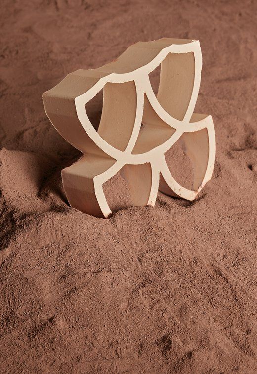 Abstract Geometric Sculpture in Tan and White on Reddish-brown Sand — Stone Arc in Kincumber, NSW