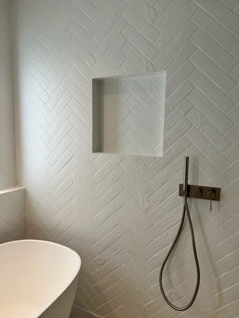 A Bathroom With A Bathtub And A Shower Head  — Stone Arc in Kincumber, NSW