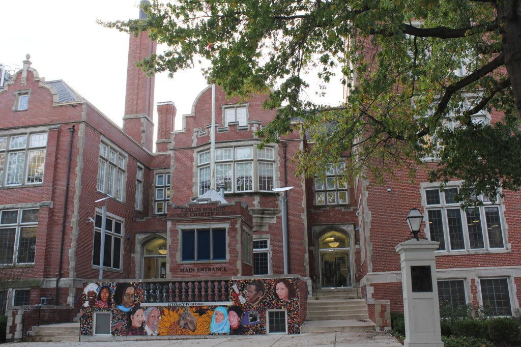 A large brick building with a tree in front of it