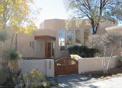A house with a wooden gate in front of it