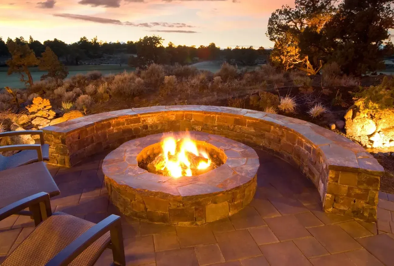 There is a fire pit in the middle of the patio.