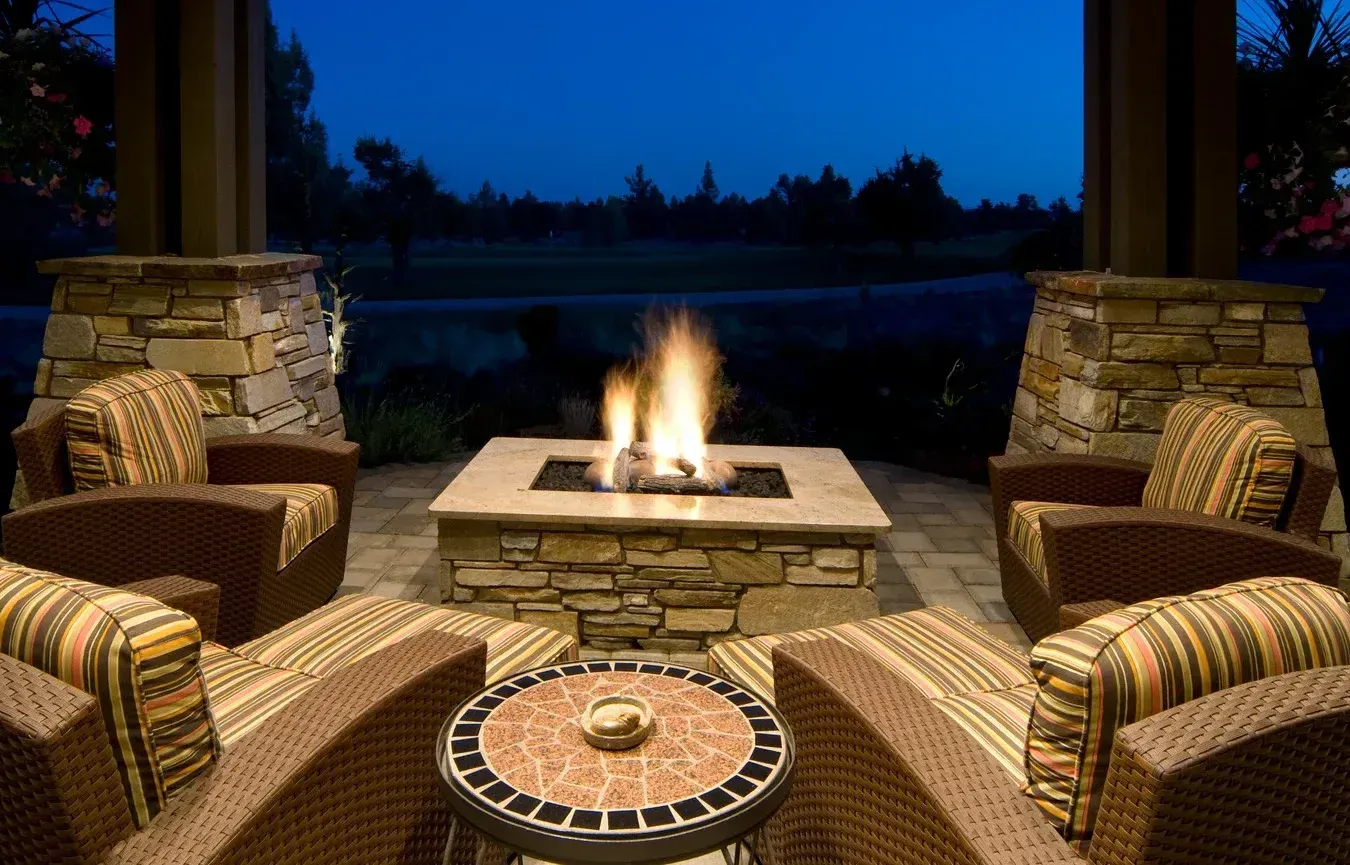 There is a fire pit in the middle of the patio.