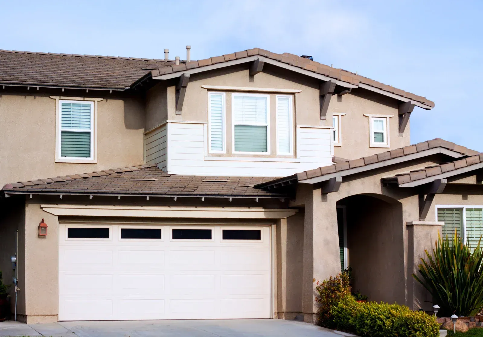 A large house with a large white garage door