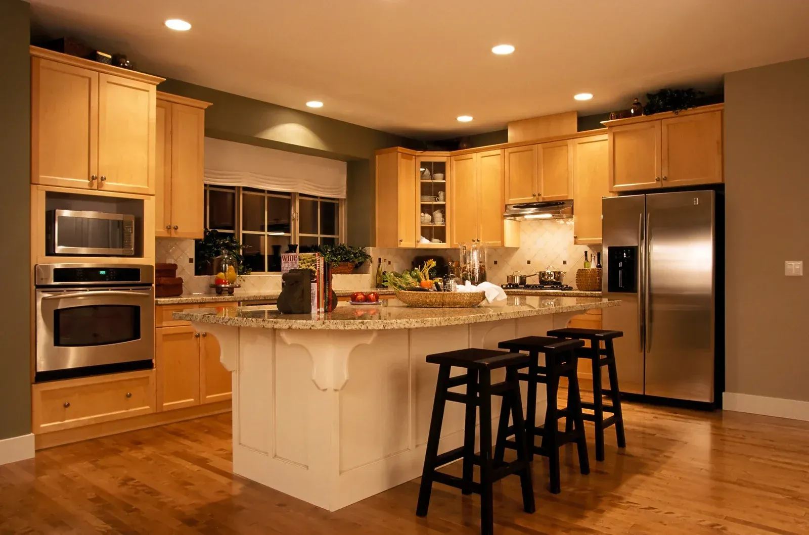 A kitchen with stainless steel appliances and wooden cabinets