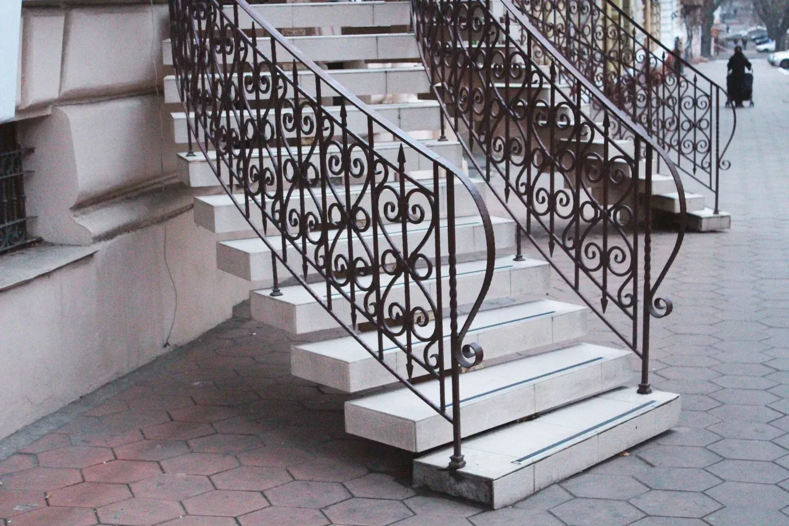 A set of stairs with a wrought iron railing