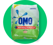 A bag of omo antibacterial laundry detergent on a green background