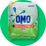 A bag of omo antibacterial laundry detergent on a green background.