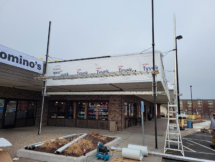A domino 's pizza restaurant is being remodeled in a parking lot.