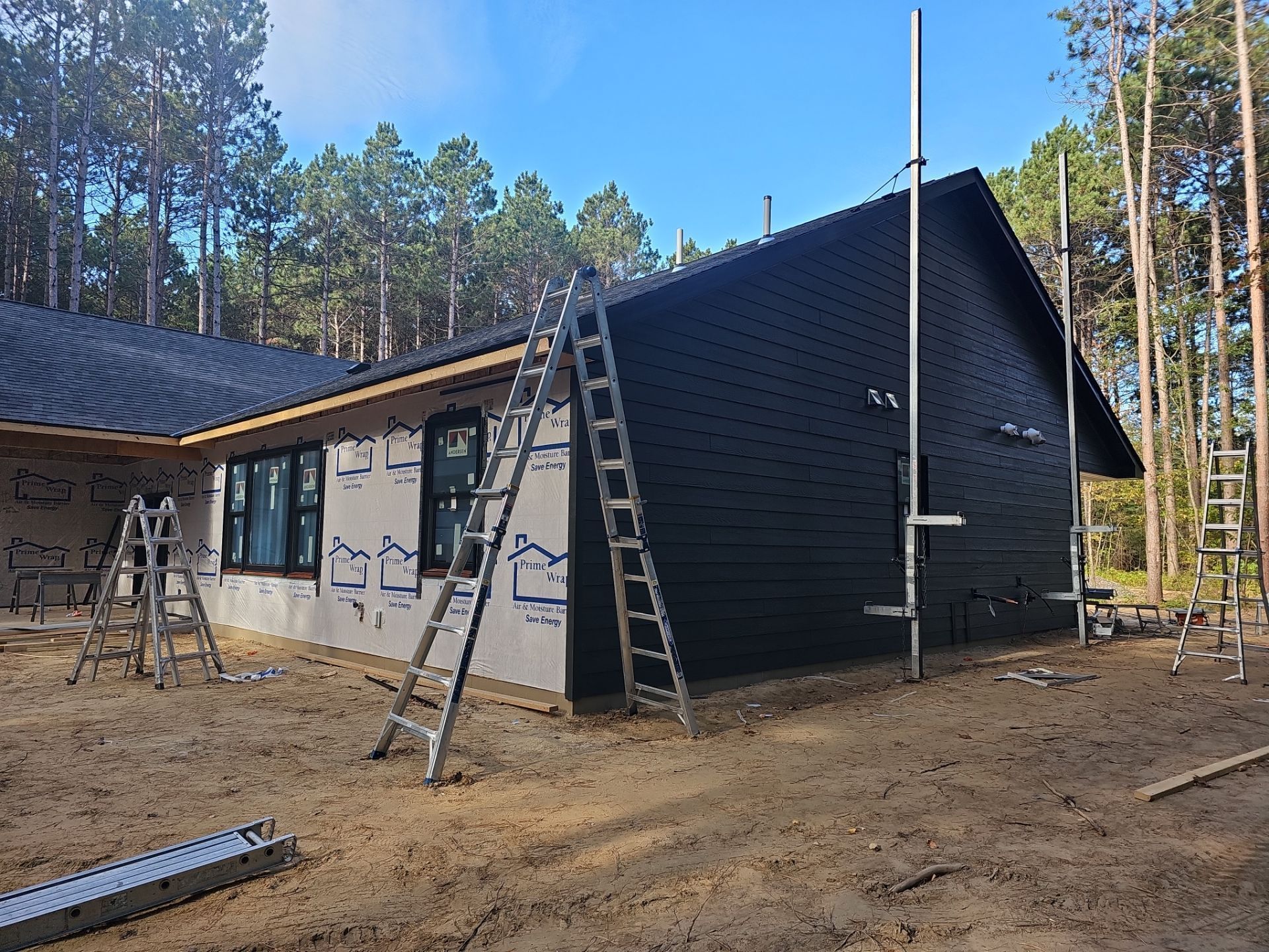 A house under construction with a ladder on the side of it.