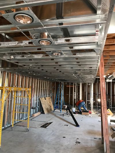 Metal Framing — Contractor Holding Blueprints in Seattle, WA