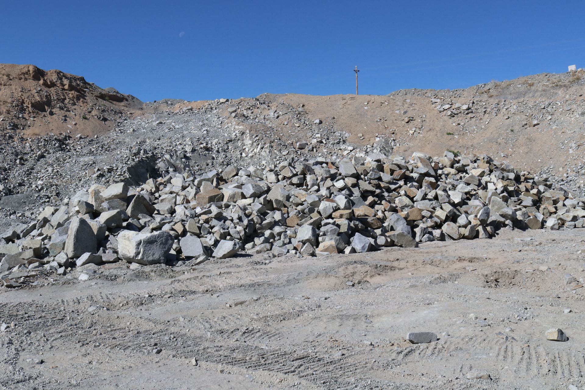 A pile of rocks in the middle of a dirt field