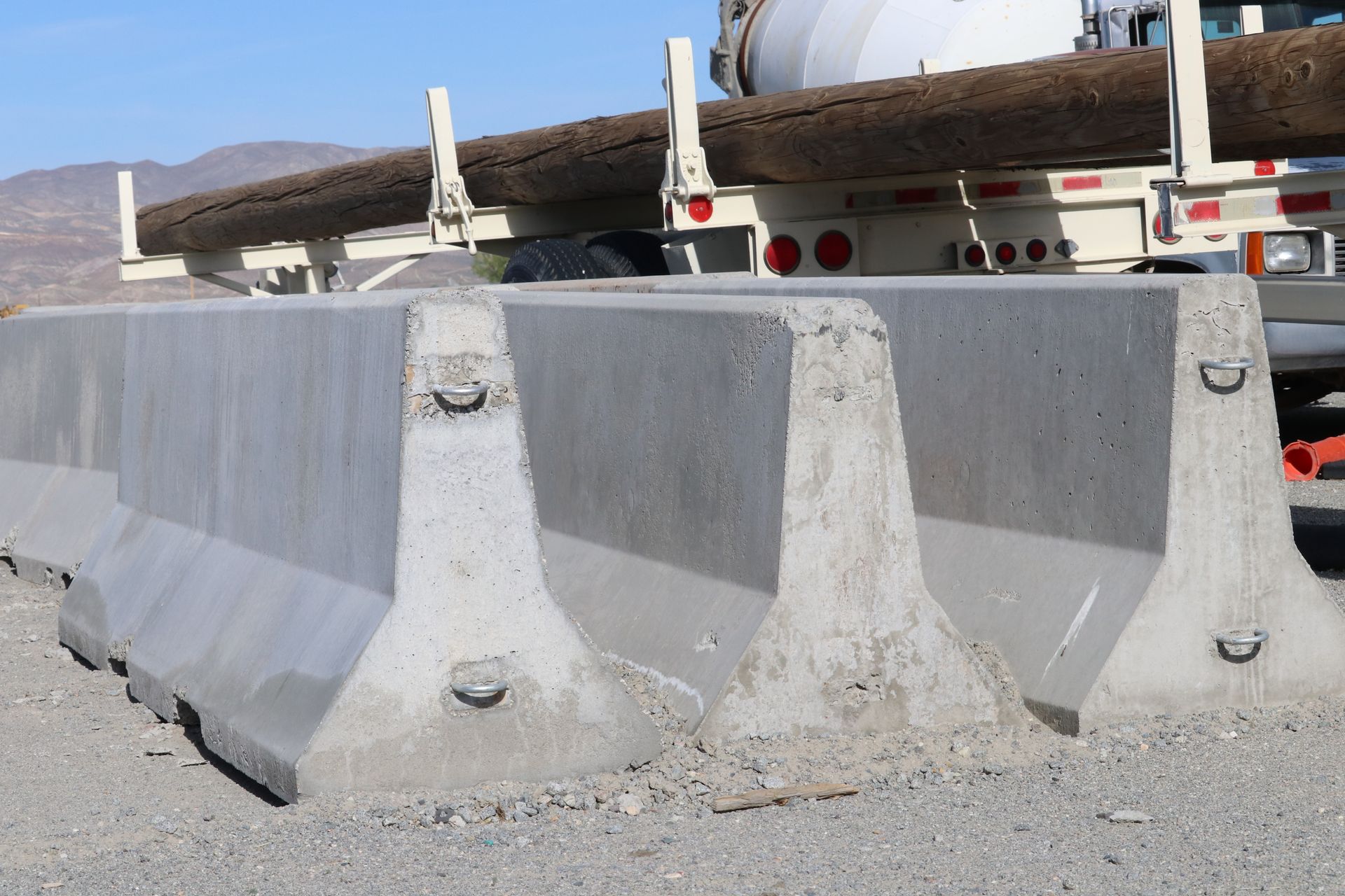 Concrete barriers on the side of a road next to a truck