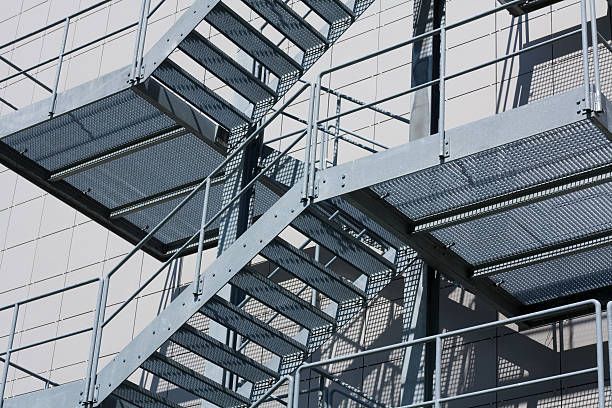 A close up of a fire escape staircase on the side of a building.