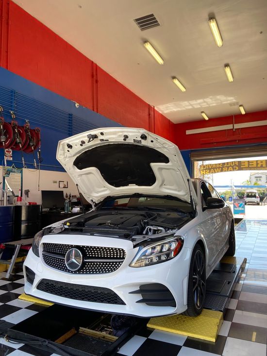 A man is working on a car in a garage.