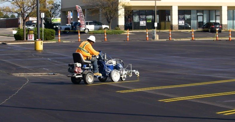 This is an image of an asphalt contractor striping a new parking lot in Glendale, Wisconsin