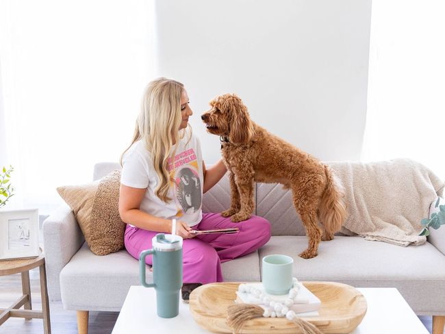 Kim Diehl Insurance Agent sitting on a couch with a dog wearing a t-shirt that says the beatles