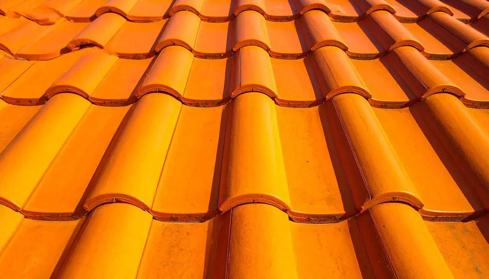 Orange ceramic roof tiles, close-up view.