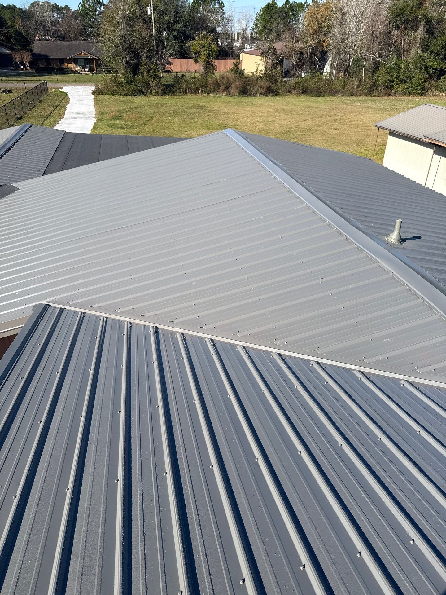Metal roof sections of varying shades of gray, angled view.