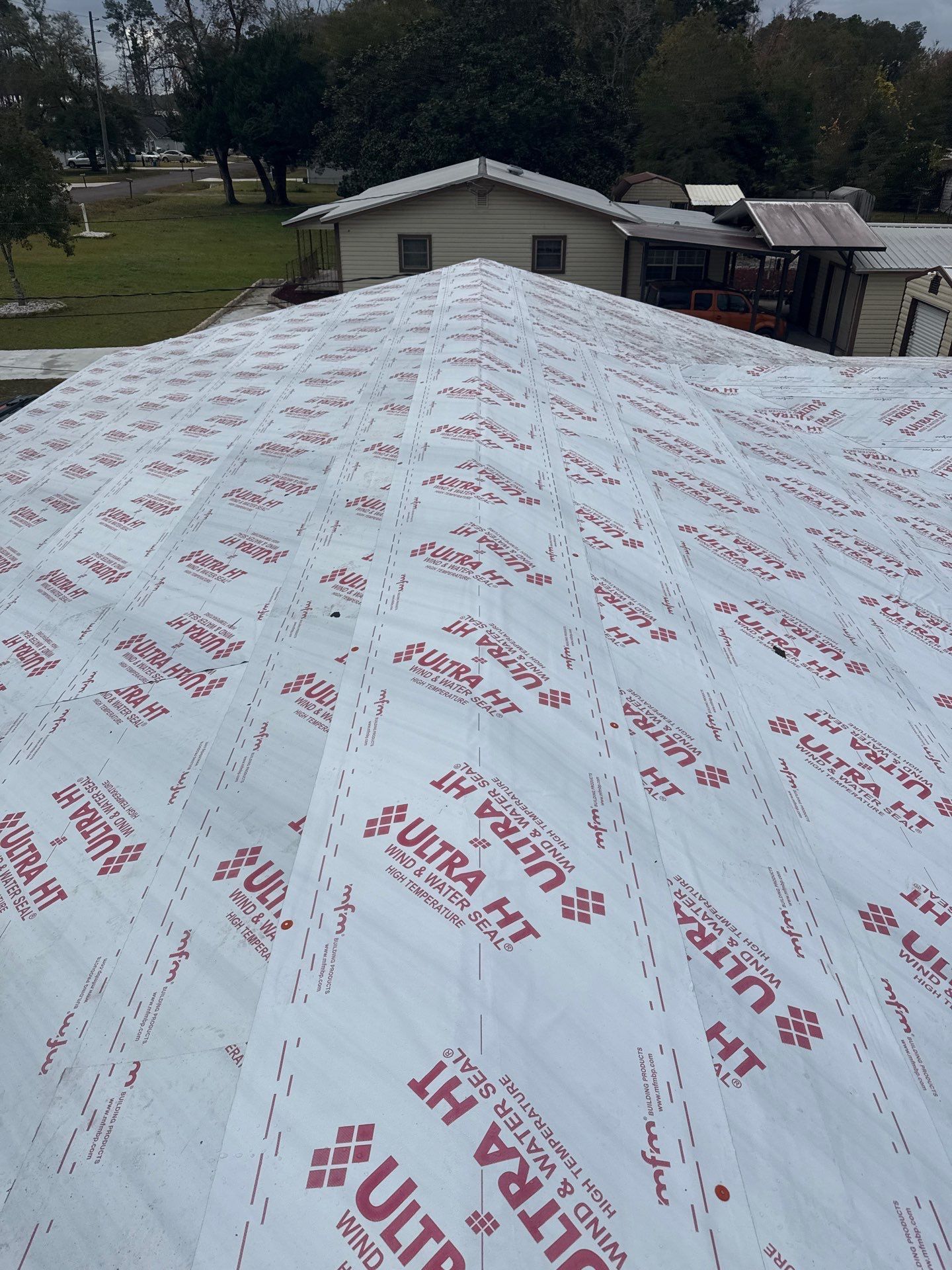 Roof covered with white underlayment, printed with red 
