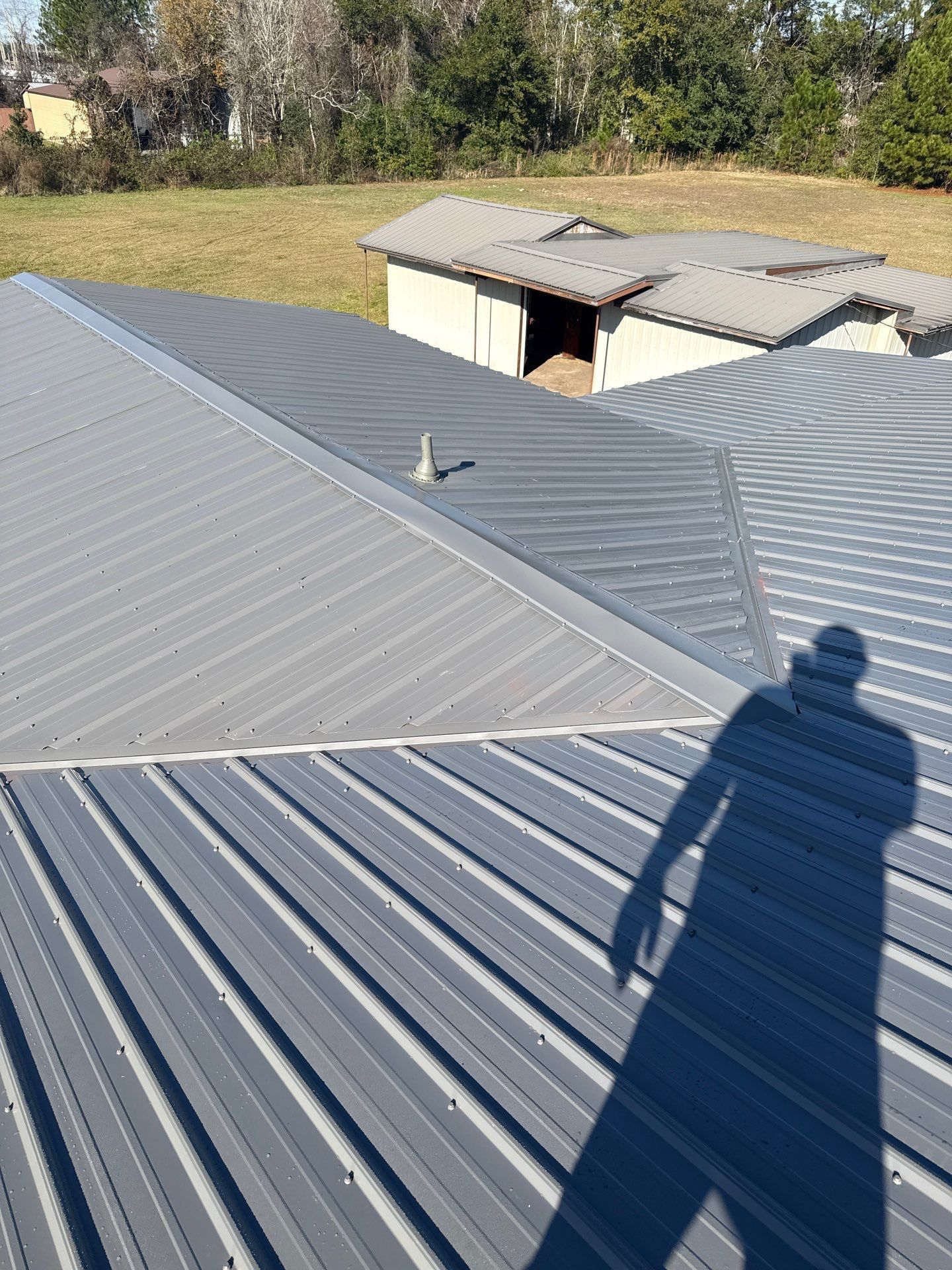 Dark brown metal roof tiles.