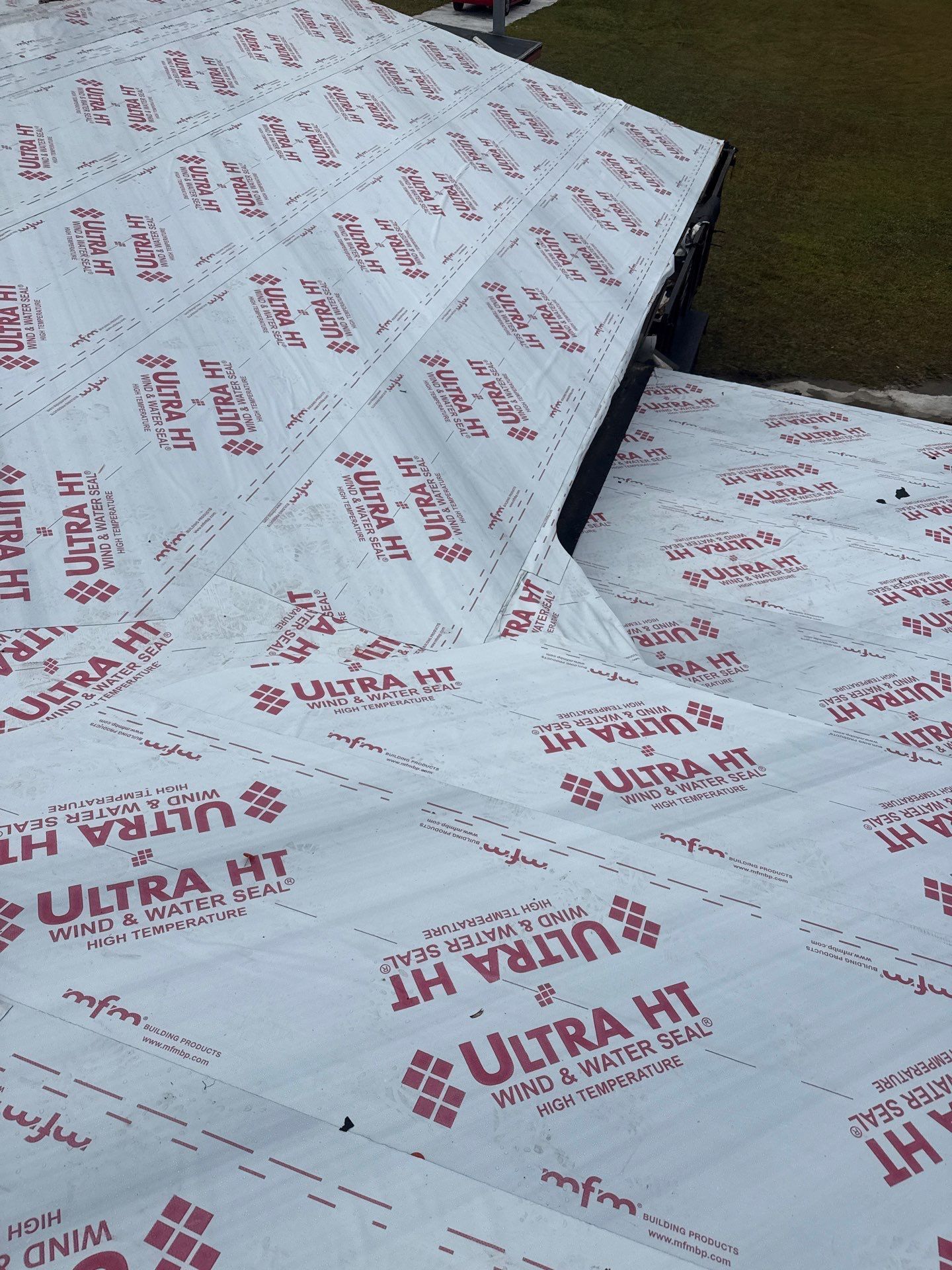 Roof covered with white Ultra HT underlayment, preparing for shingles.